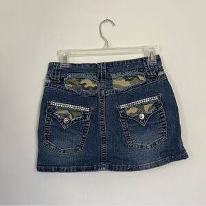 Denim jean mini skirt with camo and rhinestone detailing.